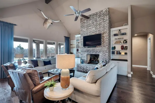 a living room with furniture a fireplace and a flat screen tv
