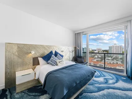 a bedroom with a bed and glass window