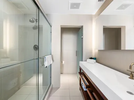 a bathroom with a sink a toilet and shower