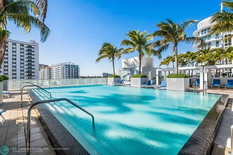 a view of swimming pool with a patio and swimming pool