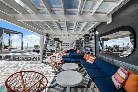 a dining room with furniture a rug and a chandelier
