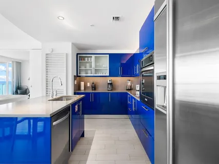 a kitchen with stainless steel appliances granite countertop a refrigerator a stove and wooden cabinets