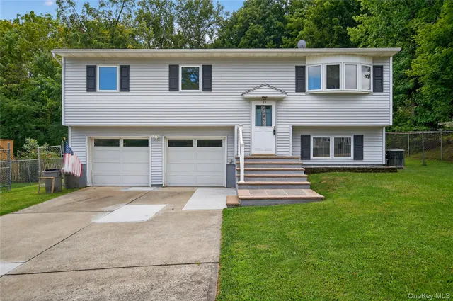 a front view of a house with a garden and yard