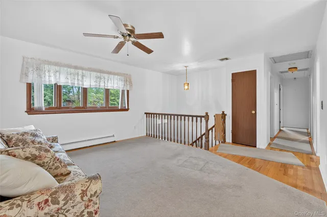 a living room with a bed furniture and a window
