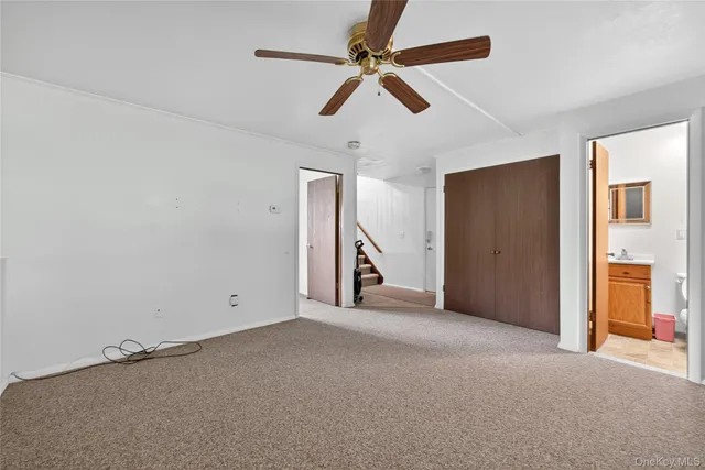 a view of empty room with ceiling fan