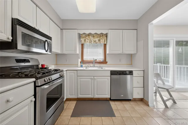 a kitchen with stainless steel appliances granite countertop a stove and a microwave