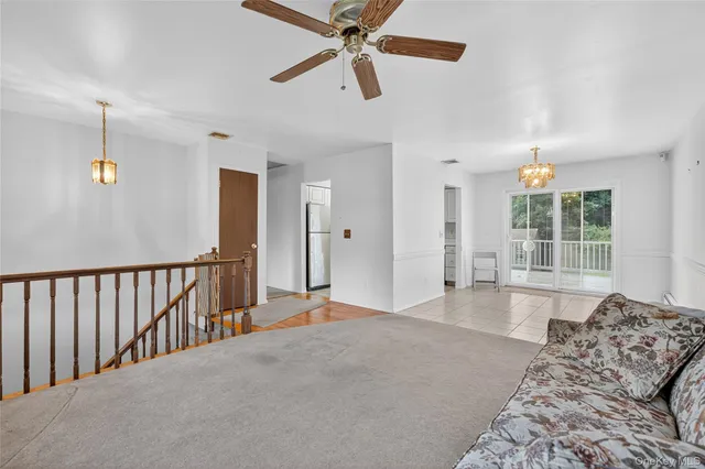 a view of a bedroom with furniture and windows