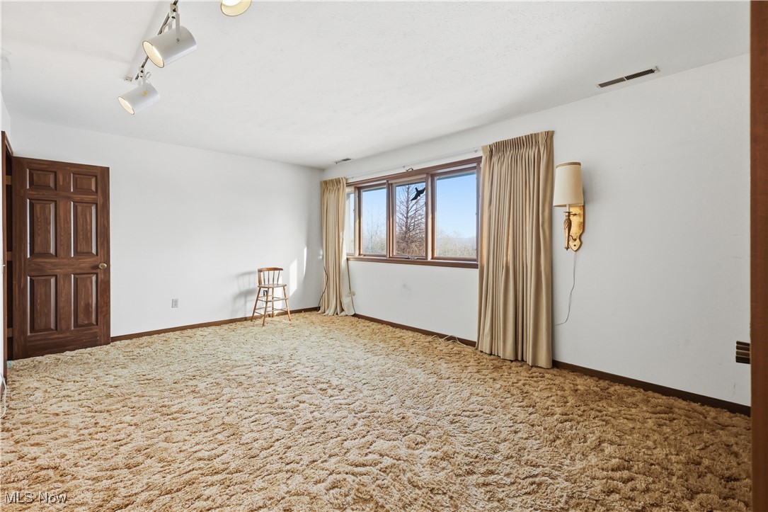 7014 River Styx Road Medina, OH 44256 - Photo 31 of 49 Carpeted empty room with baseboards and track lighting