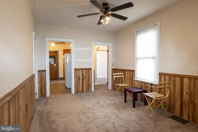a view of a livingroom with furniture and a window