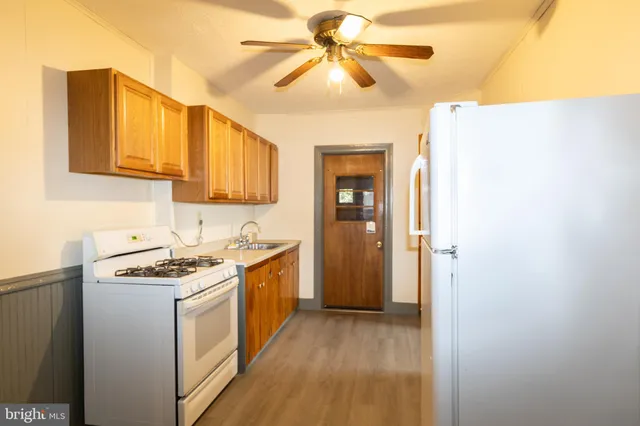 a kitchen with stainless steel appliances granite countertop a stove and a refrigerator