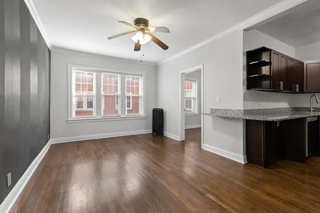 a view of kitchen with granite countertop stainless steel appliances stove and wooden floor