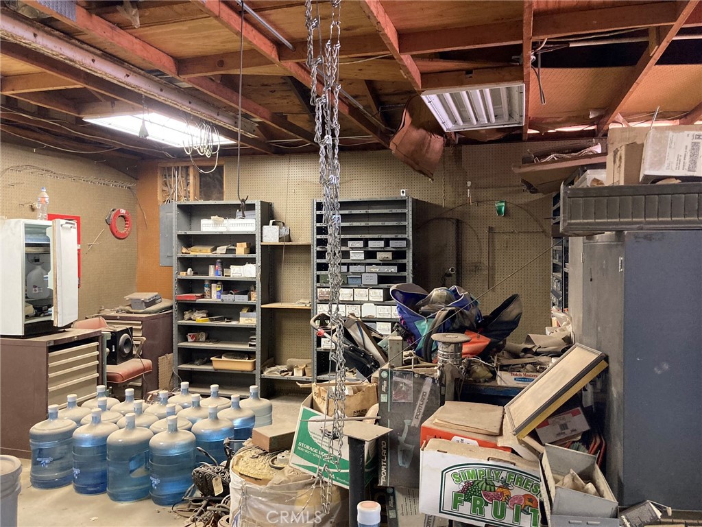 35127 Condor Road Newberry Springs, CA 92365 - Photo 26 of 60 a view of a storage room with water heater and racks