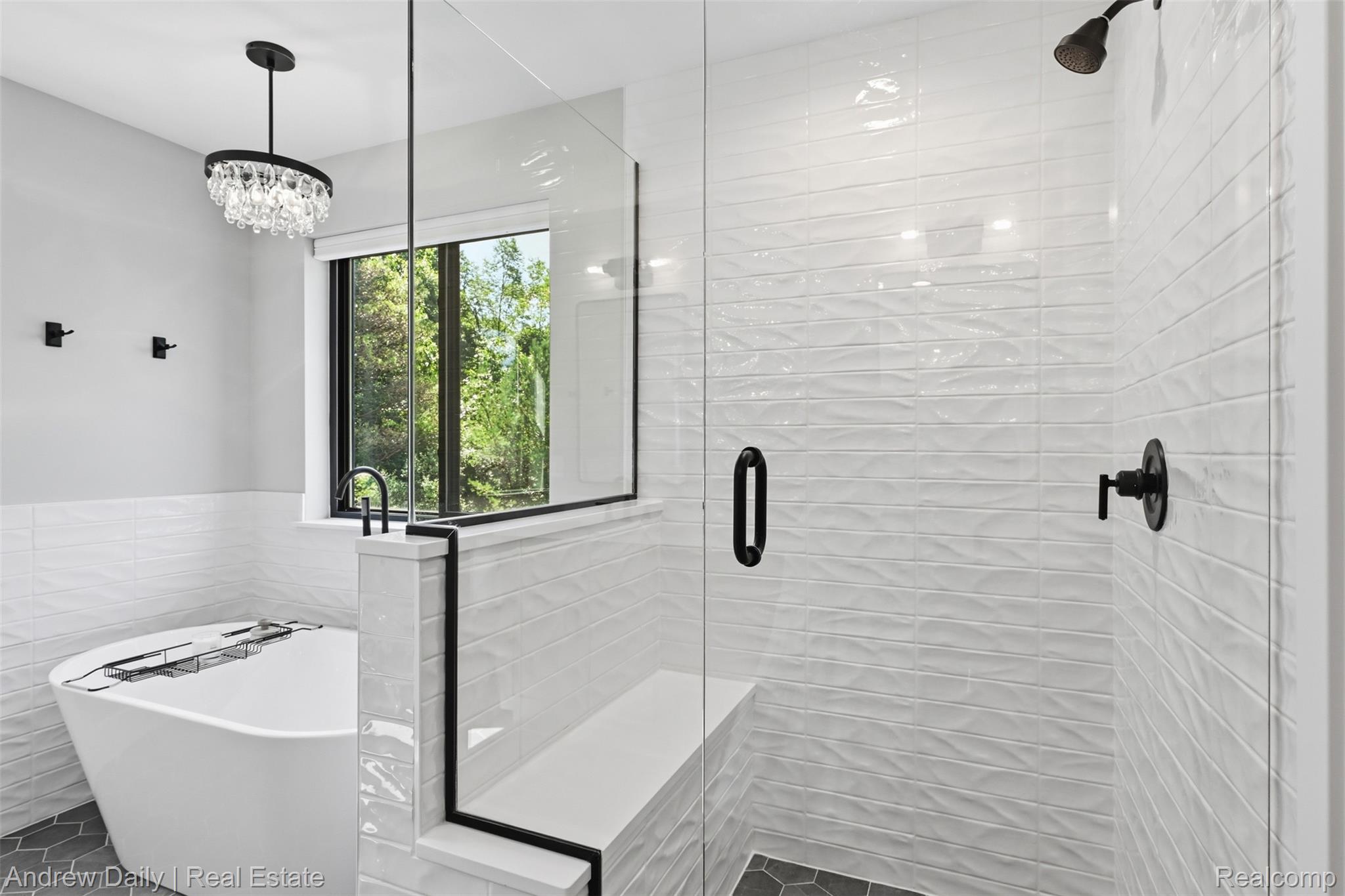 4661 Spears Road Pinckney, MI 48169 - Photo 38 of 56 Freestanding soaking tub and walk-in shower featuring a bench, glass enclosure, and black fixtures