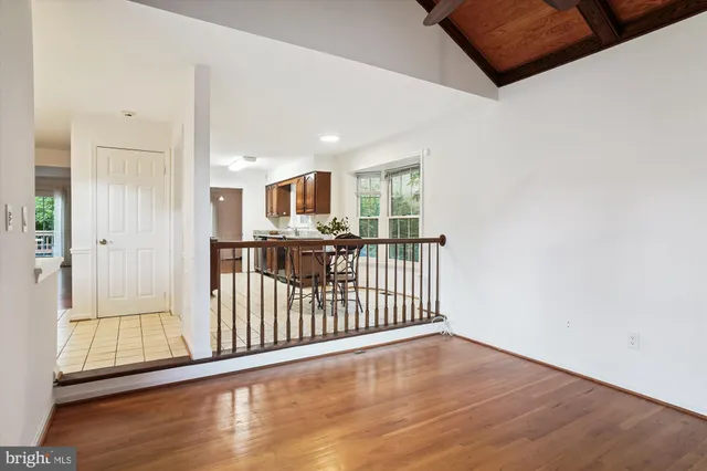 a view of a hallway with wooden floor and windows