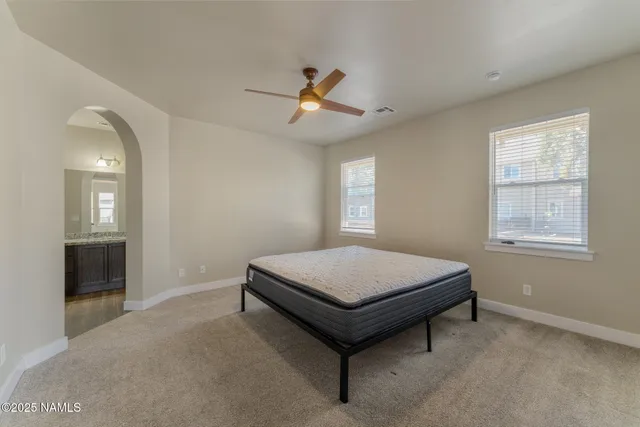 a room with pool table and windows