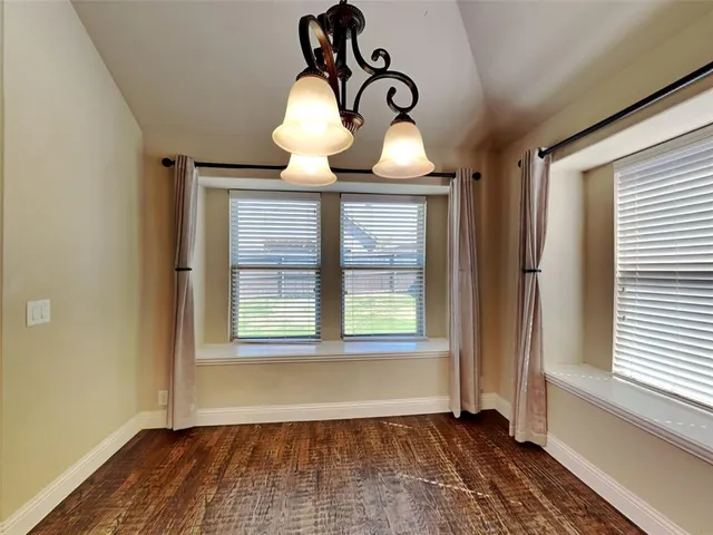 a kitchen with stainless steel appliances granite countertop a sink a stove and a microwave