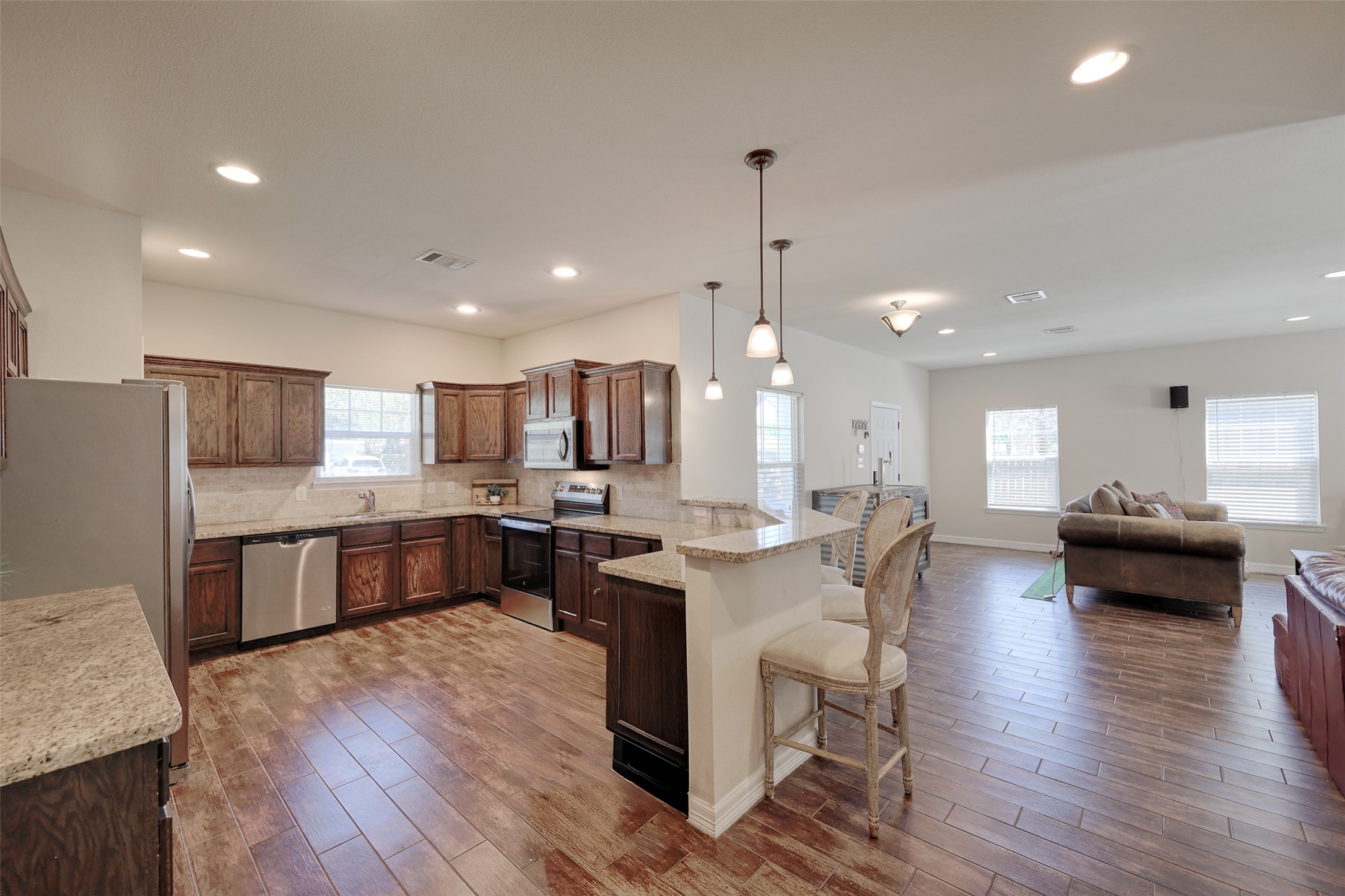1122 Detroit Street College Station, TX 77840 - Photo 48 of 48 Open floor plan boasts upgraded kitchen appliances, granite counters and breakfast bar open to the dining area and living room.