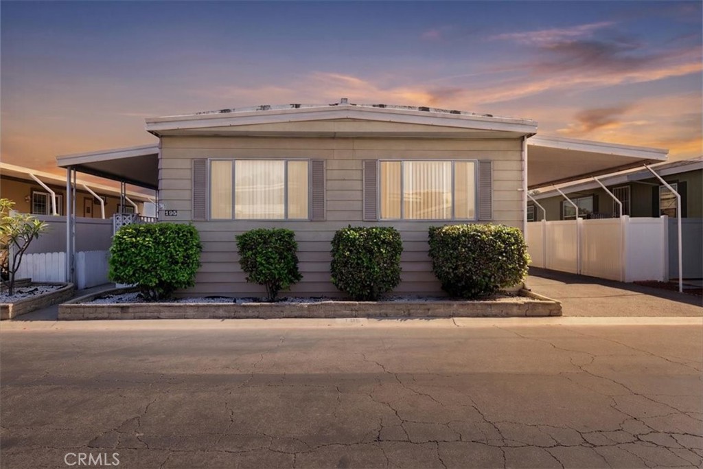 300 North Rampart Street, Unit 195 Orange, CA 92868 - Photo 1 of 25 a front view of a house with garage and plants