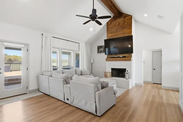a living room with fireplace furniture and a flat screen tv