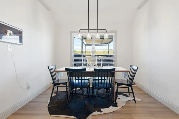 a view of a dining room with furniture window and wooden floor