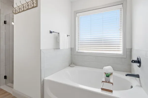 a white bath tub sitting next to a white sink