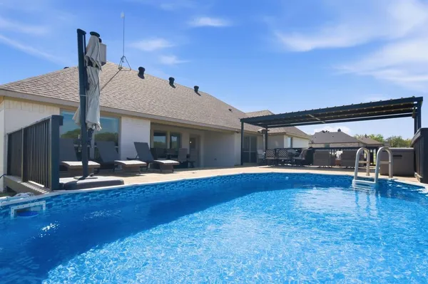 a view of house with yard and outdoor seating
