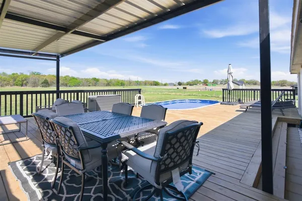 a view of a roof deck with furniture