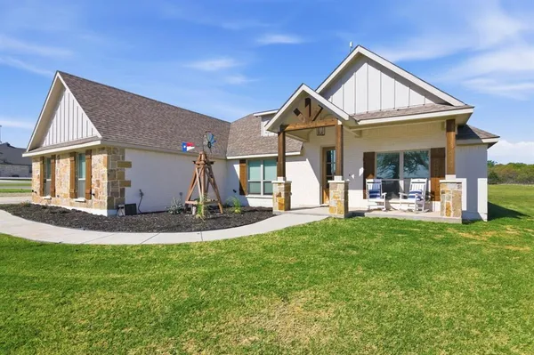 a view of a house with a yard patio and slide