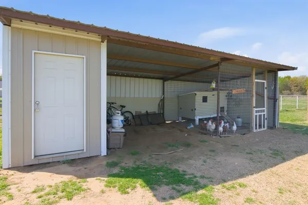 a view of two chairs in the backyard