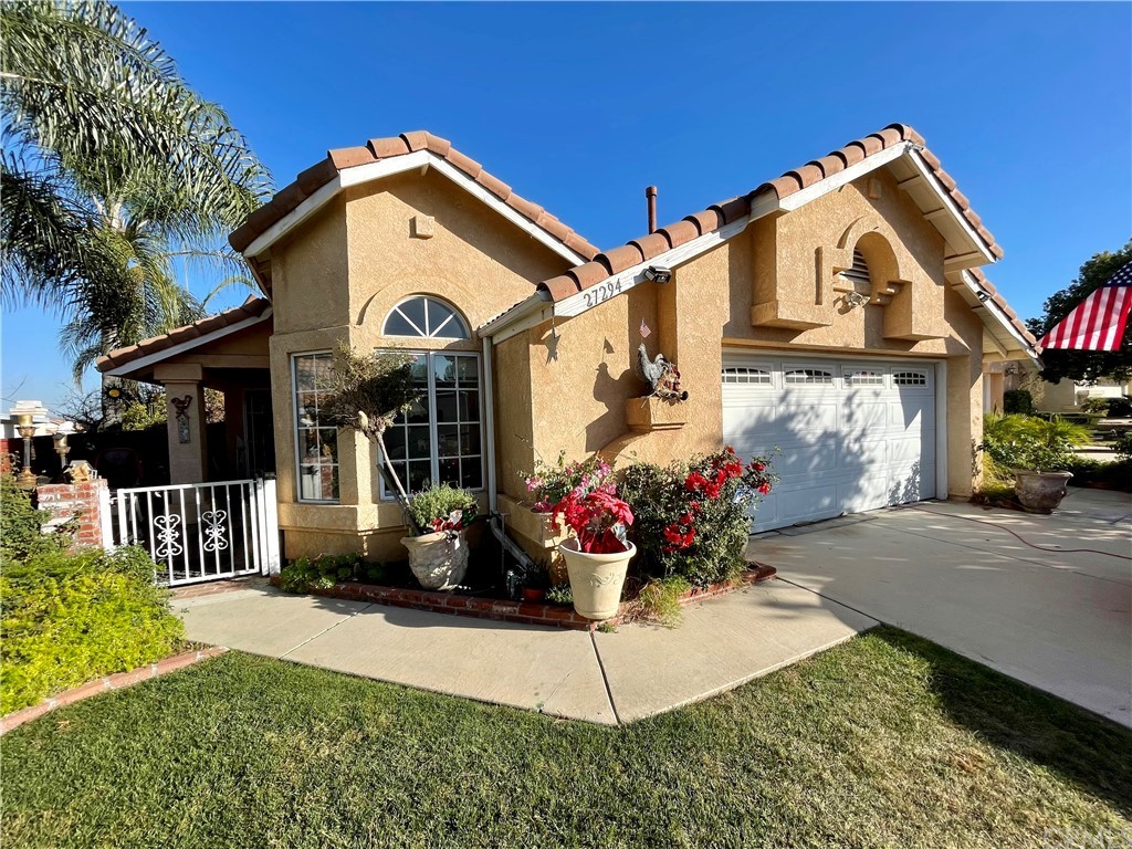 27294 Family Circle Menifee, CA 92586 - Photo 1 of 1 a front view of a house with a garden