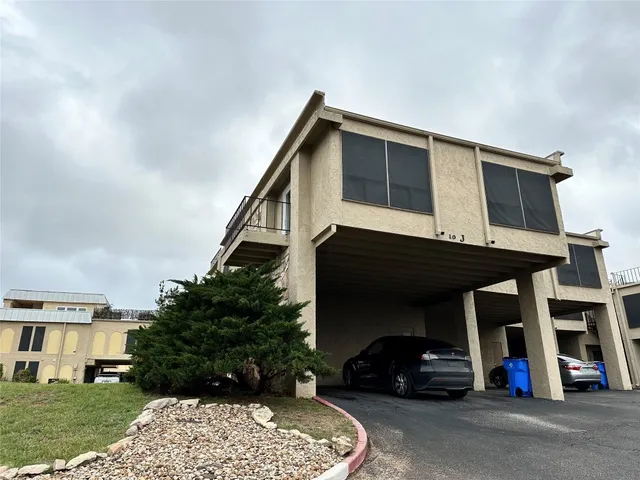 a view of building with car parked