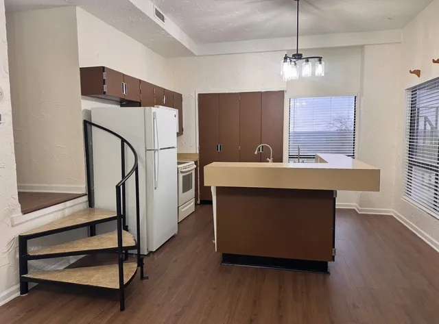 a room with table chairs and wooden floor