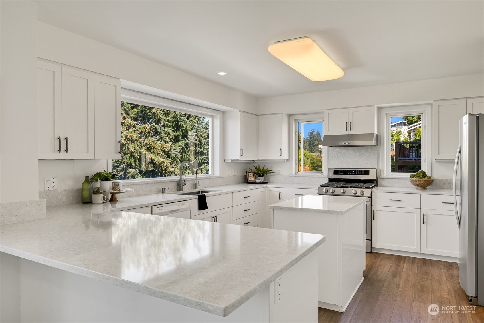 215 Bayside Road Bellingham, WA 98225 - Photo 12 of 38 a kitchen with stainless steel appliances granite countertop a sink a stove a microwave a counter top space and cabinets