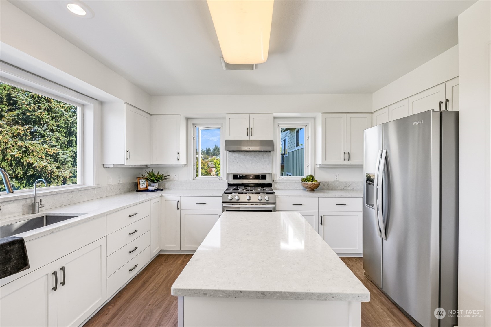 215 Bayside Road Bellingham, WA 98225 - Photo 13 of 38 a kitchen with white cabinets and stainless steel appliances