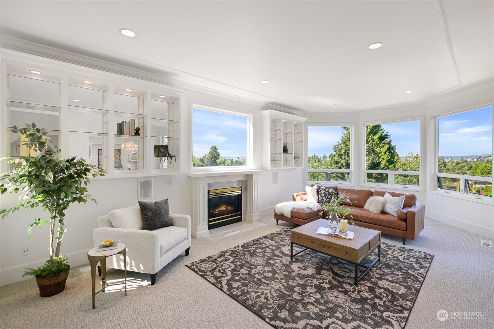 215 Bayside Road Bellingham, WA 98225 - Photo 4 of 38 a living room with furniture potted plant and a fireplace