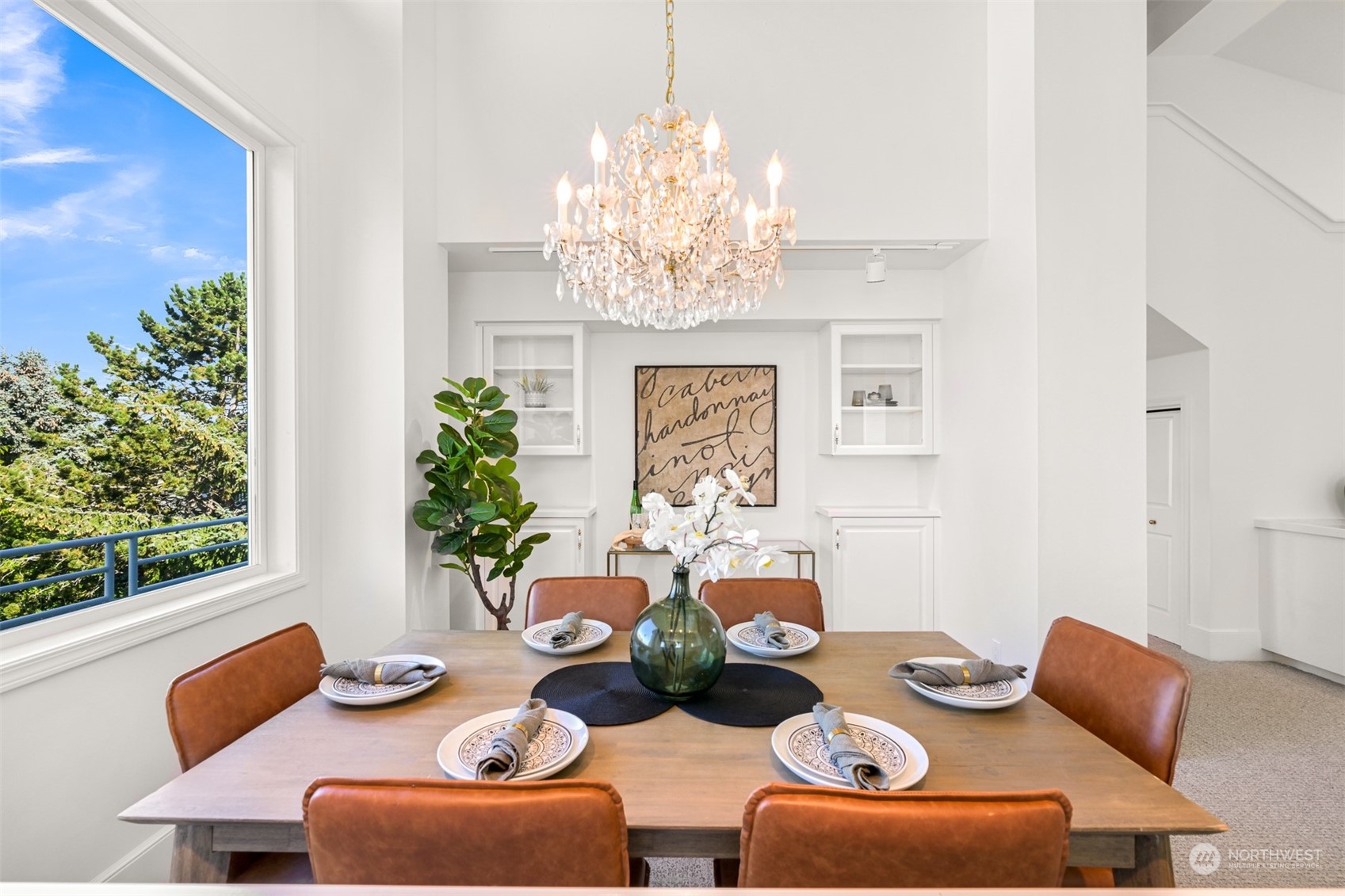 215 Bayside Road Bellingham, WA 98225 - Photo 8 of 38 a view of a dining room with furniture a chandelier and wooden floor