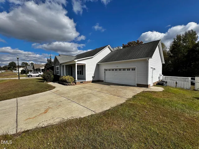 a view of empty room with wooden floor fireplace and window