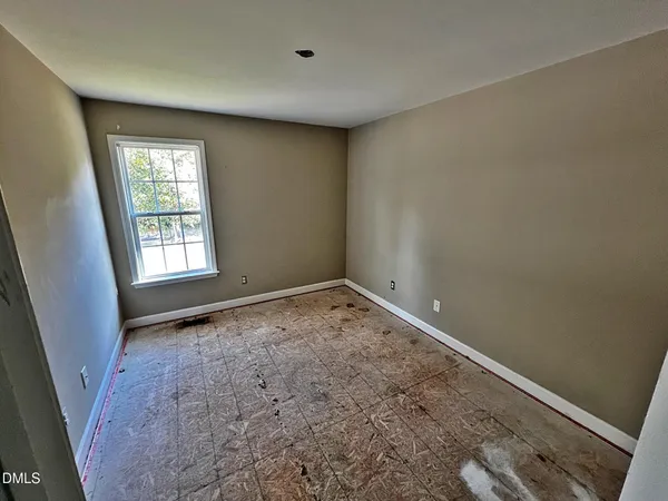 a view of backyard with barbeque grill and wooden fence