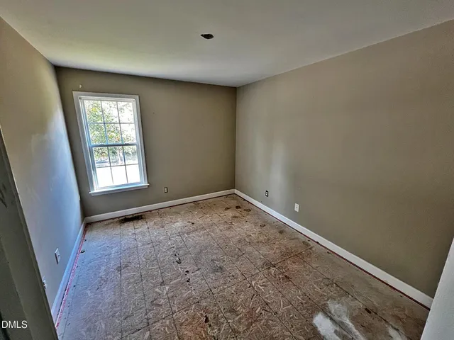 a view of backyard with barbeque grill and wooden fence