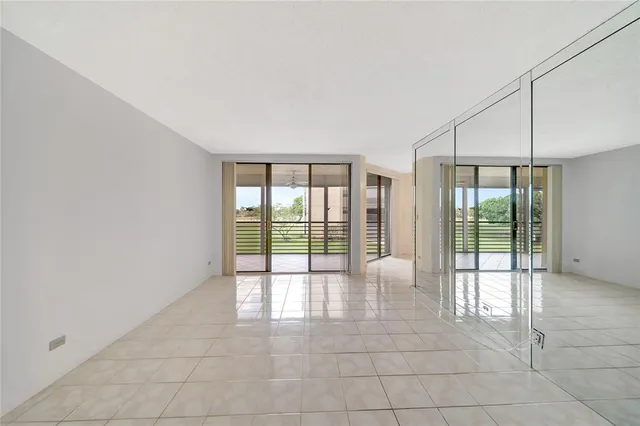 a kitchen with granite countertop a sink stainless steel appliances and white cabinets