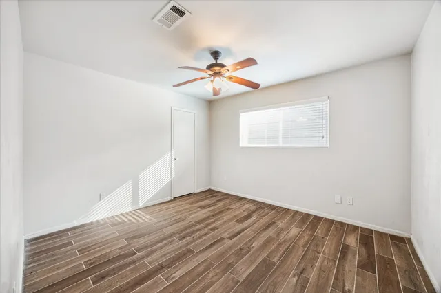 wooden floor in an empty room with a window