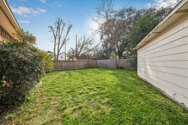 a view of yard with trees in the background
