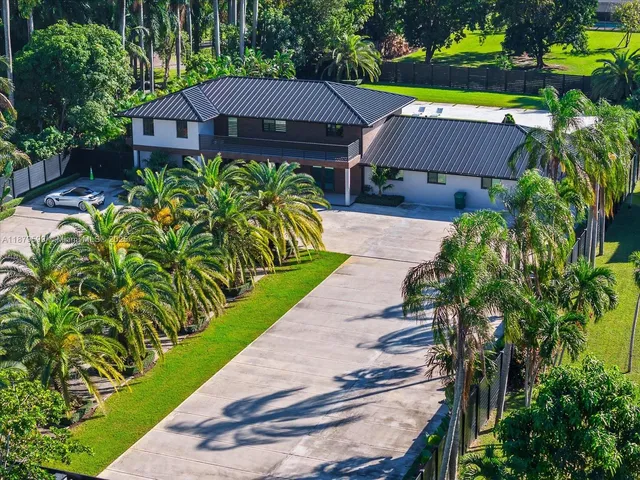 a aerial view of a house with a yard and potted plants
