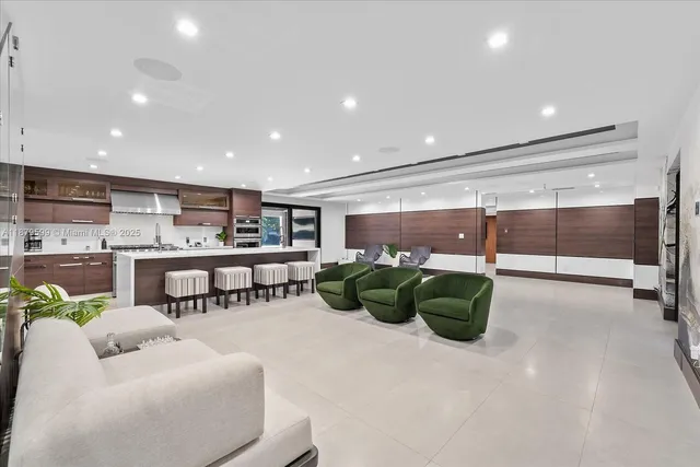 a dining room with furniture and a floor to ceiling window