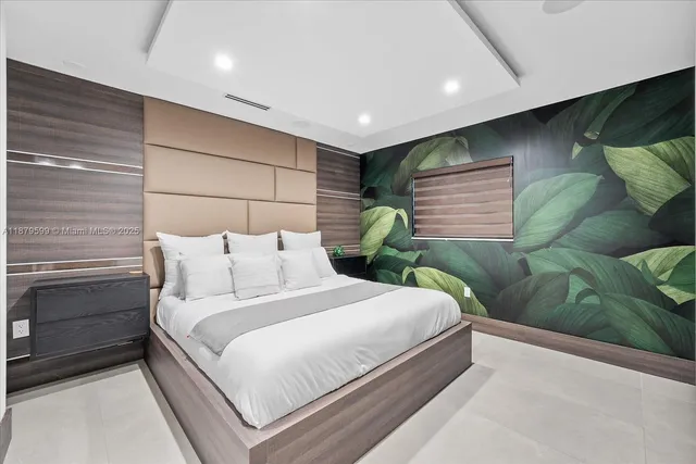 a bedroom with a bed and a flat screen tv