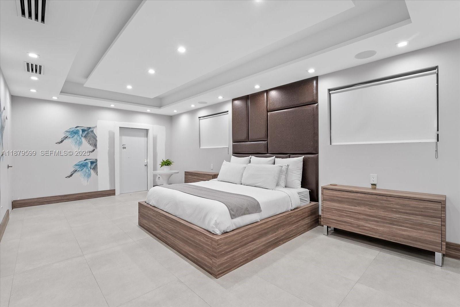 280 Northeast 156th Street Miami, FL 33162 - Photo 29 of 37 a spacious bedroom with a bed and a painting on the wall