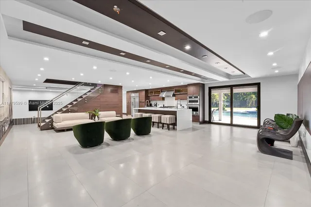 a living room with stainless steel appliances kitchen island granite countertop furniture and a kitchen view