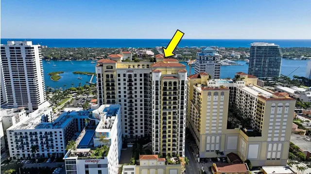 a view of a patio with couches and table and chairs under an umbrella