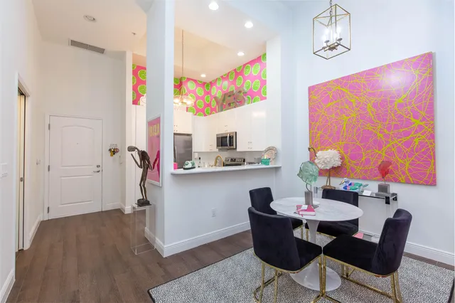 a view of a dining room with furniture a chandelier and wooden floor