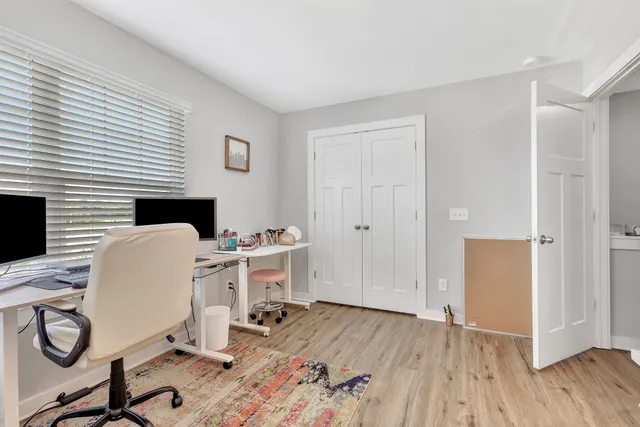 a view of a workspace with furniture and wooden floor